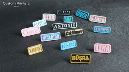 Custom galaxy-patterned Crocs with personalized name charms 'AZRA' and '#fashion' from Custom Printery Berlin, worn with white socks in an indoor setting