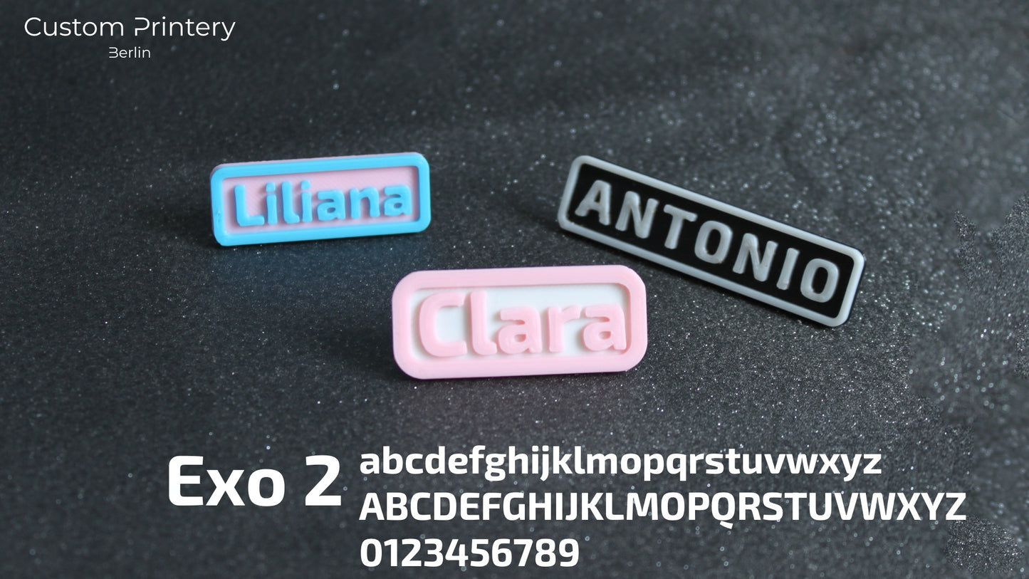 Custom galaxy-patterned Crocs with personalized name charms 'AZRA' and '#fashion' from Custom Printery Berlin, worn with white socks in an indoor setting